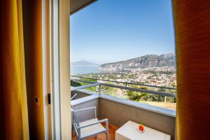 a room with a balcony with a view of the ocean at Art Hotel Gran Paradiso in Sorrento