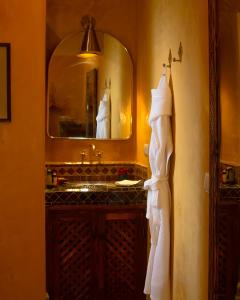 a bathroom with a sink and a mirror at Riad Alena in Marrakesh