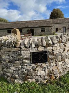 a stone wall in front of a building at The Barn Studio in Millers Dale