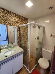 a bathroom with a shower and a toilet and a sink at Village Mediterrâneo in Cabo de Santo Agostinho +17 photos