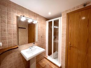 a bathroom with a sink and a mirror at Apartament Boet - Ainet de Cardós in Vall de Cardos