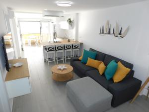 a living room with a couch and a table at PERLA Penthouse in Gran Tarajal