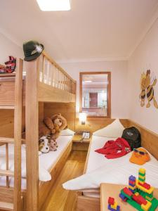 a bedroom with two bunk beds and a ladder at Familienresort Buchau in Maurach