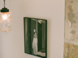 a picture of a woman in a dress on a wall at Mona Athens in Athens