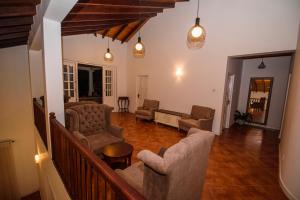 a living room with couches and chairs on a staircase at Kingsman House in Kandy