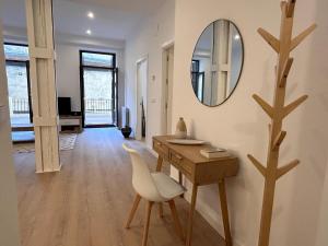 Habitación con escritorio y espejo en la pared. en Churruca apartment with terrace, en San Sebastián