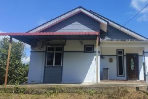 a small white house with a red roof at Azhar Homestay in Jitra