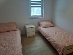 Posteľ alebo postele v izbe v ubytovaní Słoneczna Sielanka domki w Bieszczadach