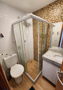 a bathroom with a shower and a toilet and a sink at Village Mediterrâneo in Cabo de Santo Agostinho
