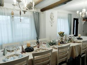 a white dining room with a table and chairs at Vila Chic M in Moieciu de Jos