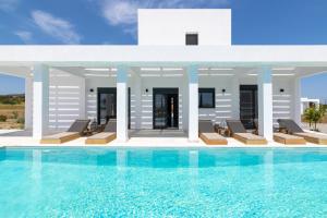 a villa with a swimming pool and lounge chairs at Seastar Villa, Lachania Beach in Lachania