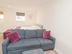 a living room with a couch and a bed at Cherry Studio in Cornhill-on-tweed