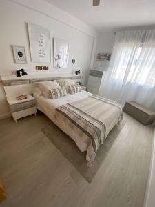 a bedroom with a bed in a white room at Duque Mar 1, Torre del mar - HOME RENT MALAGA in Torre del Mar