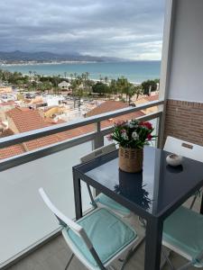 a table and chairs on a balcony with a view of the ocean at Duque Mar 1, Torre del mar - HOME RENT MALAGA in Torre del Mar