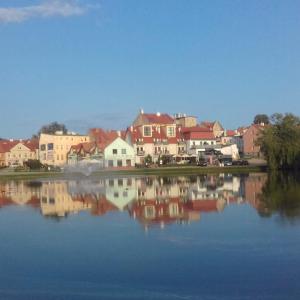 a group of houses sitting next to a body of water at Okno na Ratusz De Luxe in Mrągowo