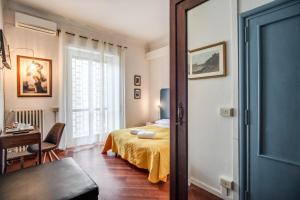 a bedroom with a bed and a desk and a window at Circus Maximus B&B in Rome