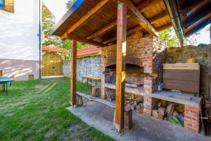 an outdoor kitchen with a brick oven in a yard at Villa Hills in Janja Gora