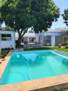 a swimming pool in the yard of a house at Wishford Cottage on Worcester in Grahamstown