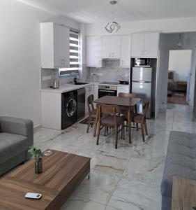 a kitchen and living room with a table and chairs at ICEBUILD APARTMENTS in Nicosia