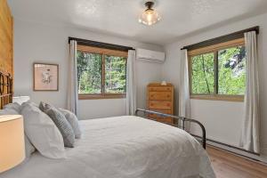 a bedroom with a bed and two windows at Nature Stay with Views Like No Where Else in Custer