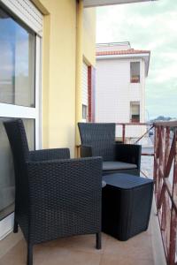 a balcony with two chairs and a table on a balcony at Brisa apart t2 in Ovar