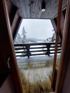 a view from the inside of a room with a window at Vikendica A Vlasic in Vlasic +11 photos
