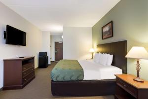 a hotel room with a bed and a television at Quality Inn & Suites in Monterey