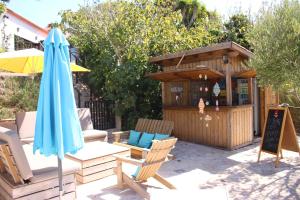 a patio with an umbrella and a building at Casa Boavista in São Martinho do Porto