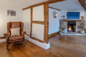 a living room with a chair and a fireplace at The Landers in Cheltenham