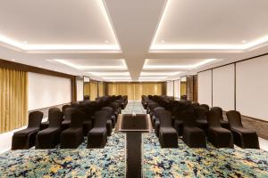 a conference room with chairs and tables in a room at Lemon Tree Premier, Mumbai International Airport in Mumbai