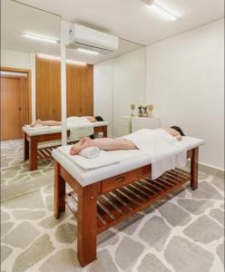 a hospital room with two beds and a mirror at Apto Salinas Exclusive Resort, 2 quartos in Salinópolis +34 photos