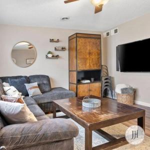 a living room with a couch and a coffee table at Pet Friendly Large Fenced Backyard Covered Patio in Rapid City