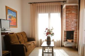 a living room with a couch and a fireplace at RVHotels Apartamentos Villas Piscis in L'Estartit
