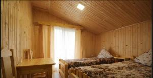 a bedroom with two beds and a window at Cube in Kvasy