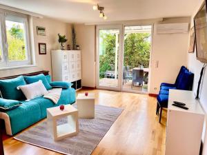 a living room with a blue couch and a table at Schöne Wohnung mit eigenen Eingang und Terrasse in Gösseling