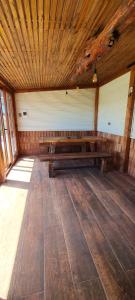 an empty room with wooden benches in a cabin at Mirador de Philippi in Puerto Varas