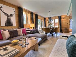 a living room with a couch and a table at Chalet Morzine, 7 pièces, 8 personnes - FR-1-627-23 in Morzine