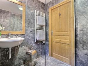 a bathroom with a sink and a wooden door at Chalet Morzine, 7 pièces, 8 personnes - FR-1-627-23 in Morzine