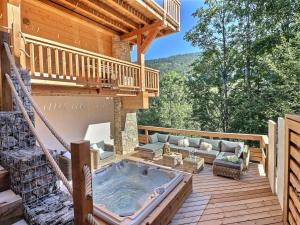 a hot tub on the deck of a log cabin at Chalet Morzine, 7 pièces, 12 personnes - FR-1-627-20 in Morzine