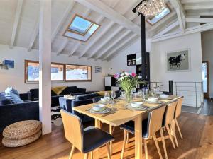 a dining room and living room with a table and chairs at Chalet Morzine, 6 pièces, 10 personnes - FR-1-627-24 in Morzine