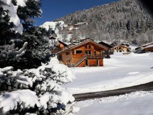 a log cabin in the snow with snow covered trees at Chalet Morzine, 6 pièces, 10 personnes - FR-1-627-24 in Morzine