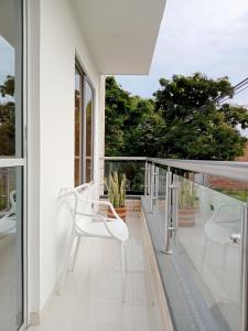 una sedia bianca sul balcone di una casa di Apartamento cerca al Centro comercial Nuestro Cartago a Cartago