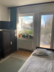 a bedroom with a bed and a window at Apartman-Donau Tát in Tát