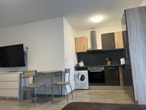 a kitchen with a table and chairs and a dishwasher at ForstStay Apartment in Forst +2 photos