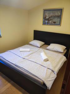 a bedroom with a bed with two pillows on it at Soleil Apartmanok Baska in Baška