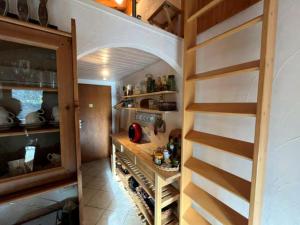 a kitchen with a staircase leading to a wine cellar at Vercorin - La Maya in Vercorin
