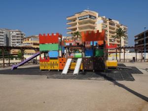 um parque infantil colorido com um escorrega numa cidade em ÁTICO-DUPLEX EN URB. PEÑISMAR en 1ª línea de playa em Peníscola