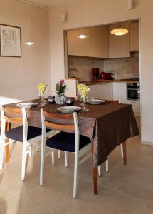 a dining room table and chairs with flowers on it at Valparaiso Koksijde in Koksijde