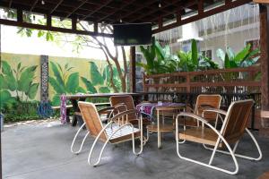 a patio with a table and chairs and a television at Nusantara Hotel Syariah in Jepara