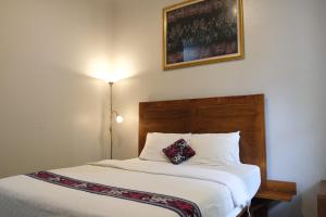 Postel nebo postele na pokoji v ubytování Nusantara Hotel Syariah